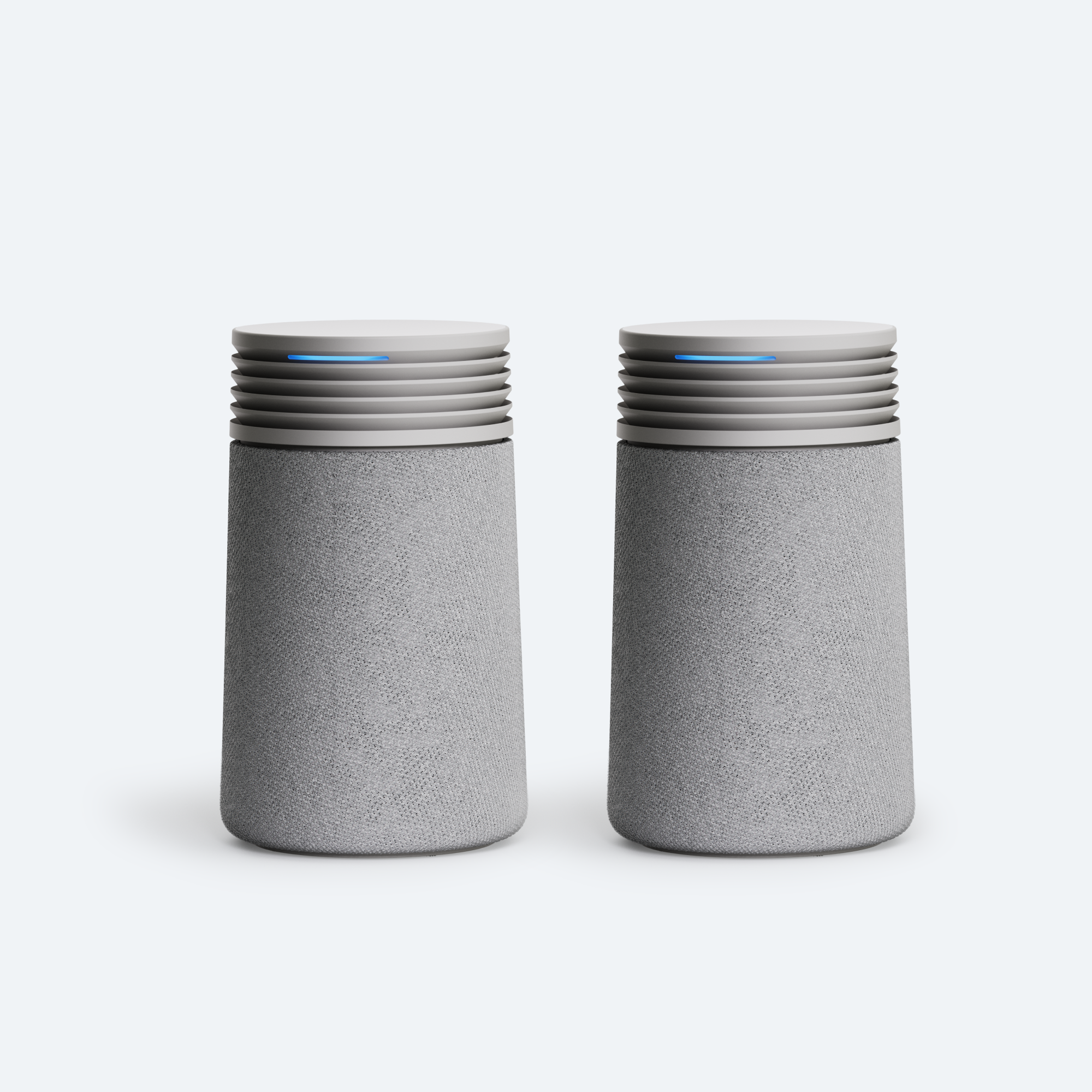 Two Blueair Blue Signature Mini units shown side by side, with textured light-gray lower sleeves, dark ridged upper panels and narrow blue indicator strips.