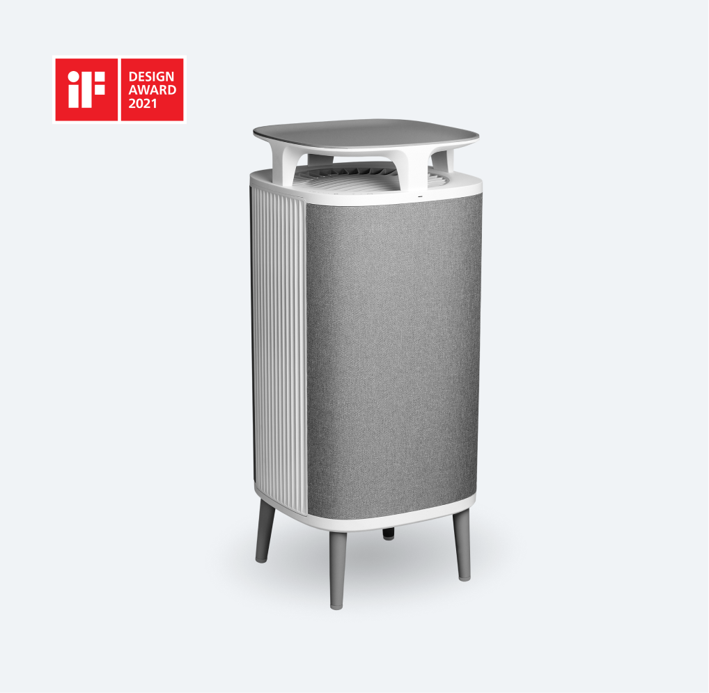 Light-grey textile-front Blueair DustMagnet 5440i standing on four legs beneath a table-like top